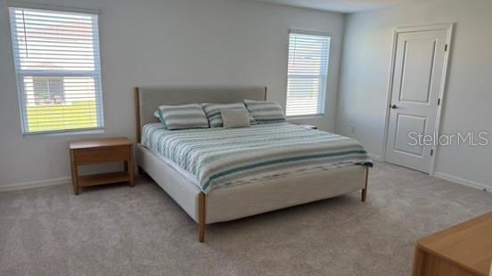 4520 Ranunculus Street Haines City, FL 33844 - Photo 14 of 19 a bed sitting in a bedroom next to a window