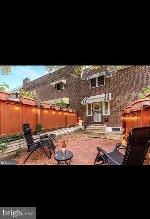 a view of a patio with table and chairs under an umbrella