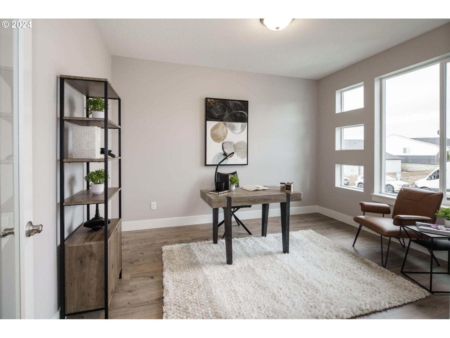 4219 North 11th Way Ridgefield, WA 98642 - Photo 14 of 32 a workspace with furniture window and a wooden floor