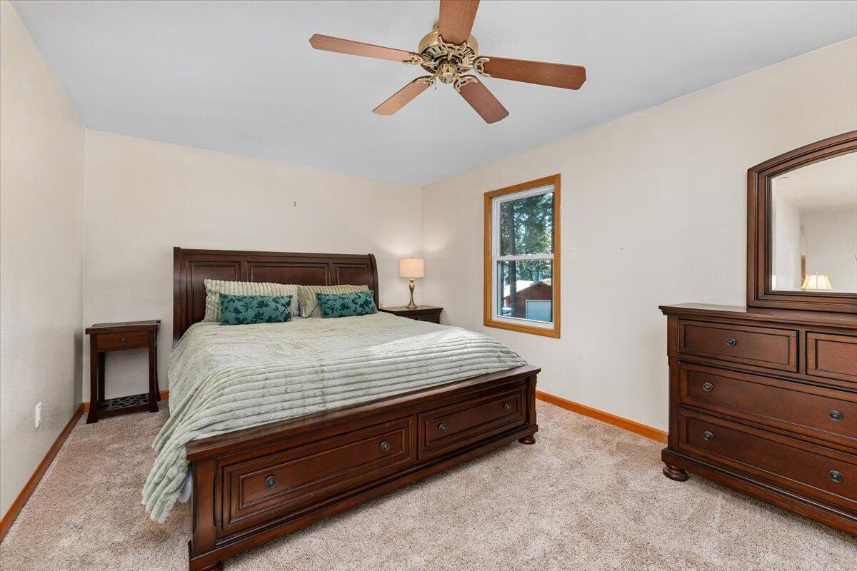 34820 Emigrant Trail Shingletown, CA 96088 - Photo 12 of 42 a bedroom with a bed and a dresser