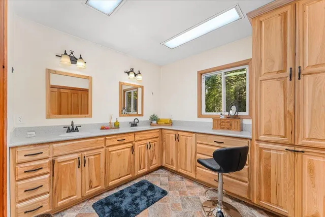 a kitchen with a sink and chairs