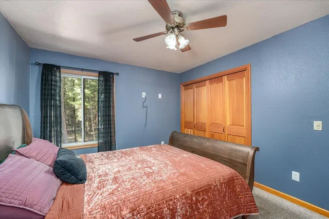 a bedroom with a large bed and a window