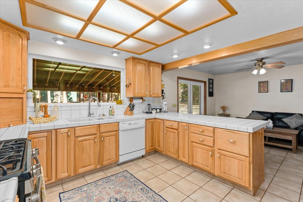 34820 Emigrant Trail Shingletown, CA 96088 - Photo 3 of 42 a large kitchen with a sink and cabinets
