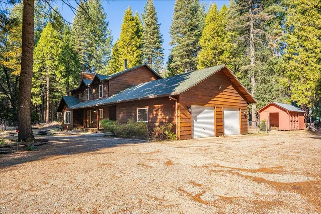 a front view of a house with a yard covered in snow
