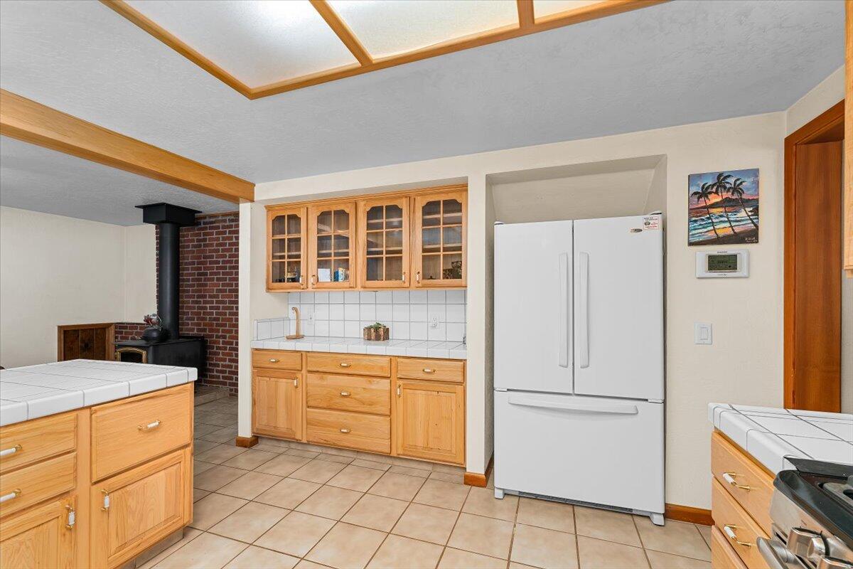 34820 Emigrant Trail Shingletown, CA 96088 - Photo 4 of 42 a kitchen with a stove a sink and a refrigerator