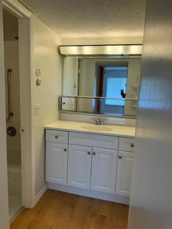 a view of a room with wooden floor and windows