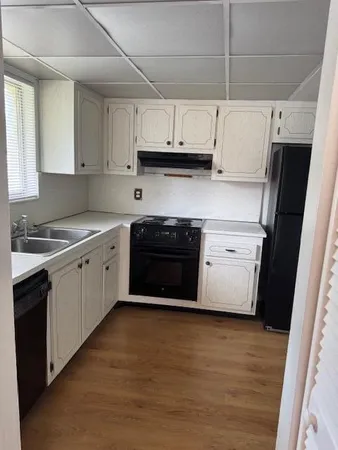 a kitchen with stainless steel appliances a stove a sink and a refrigerator