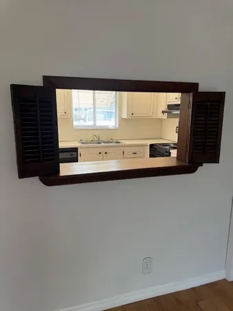 a view of a large kitchen with a large window