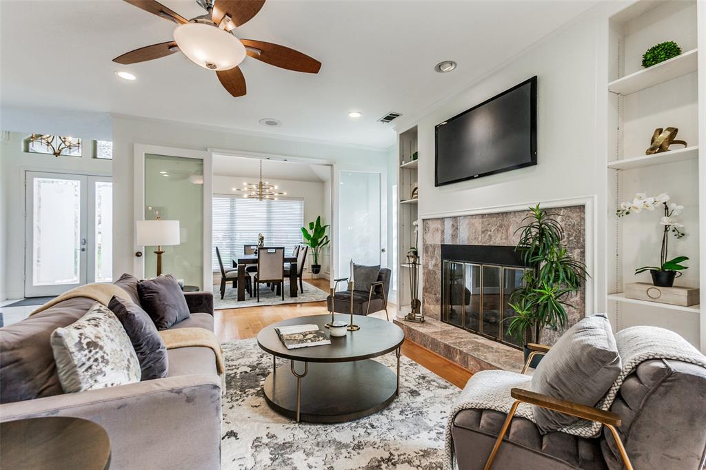 a living room with furniture a fireplace and a flat screen tv