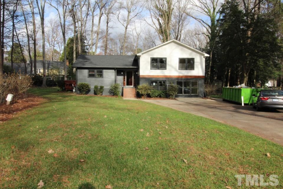 6516 Jade Tree Lane Raleigh, NC 27615 - Photo 1 of 30 a front view of a house with a yard and trees