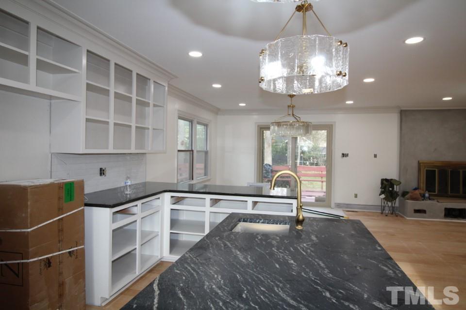 6516 Jade Tree Lane Raleigh, NC 27615 - Photo 3 of 30 a kitchen that has a lot of cabinets and wooden floor