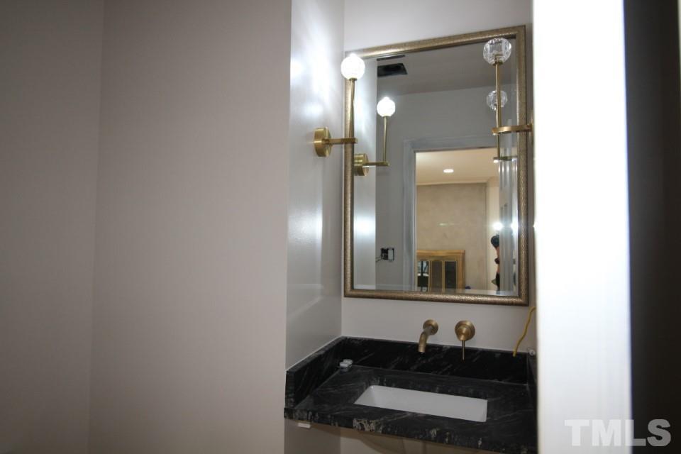 6516 Jade Tree Lane Raleigh, NC 27615 - Photo 6 of 30 a bathroom with a sink and a mirror