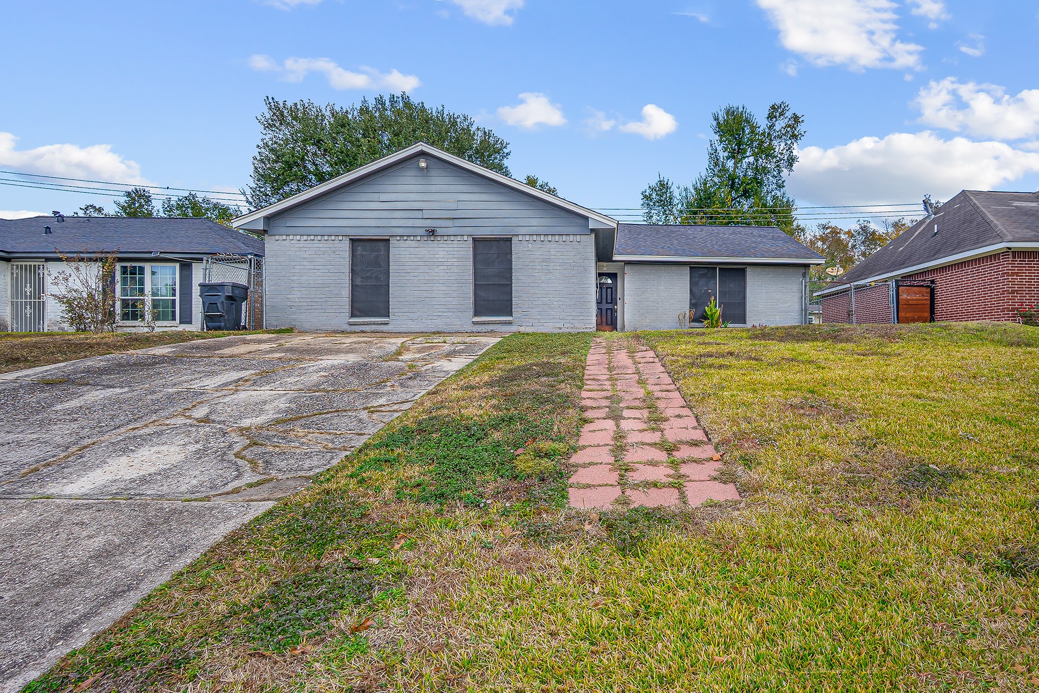 10939 Dunvegan Way Houston, TX 77029 - Photo 17 of 28 a front view of a house with a yard and garage
