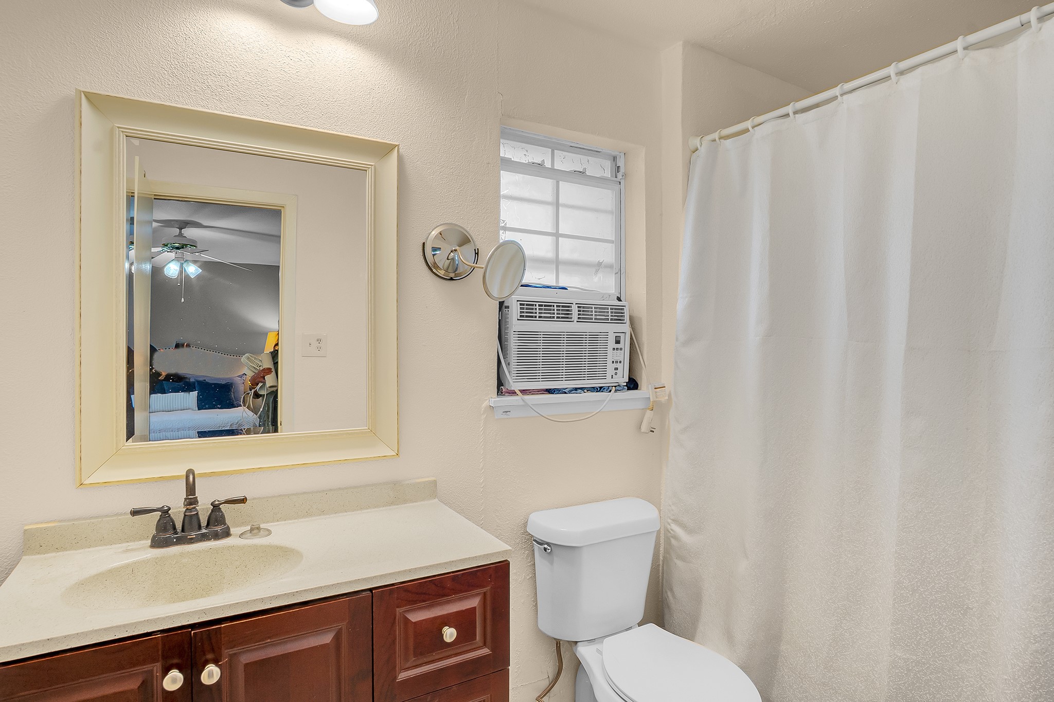 10939 Dunvegan Way Houston, TX 77029 - Photo 19 of 28 a bathroom with a sink vanity mirror and toilet