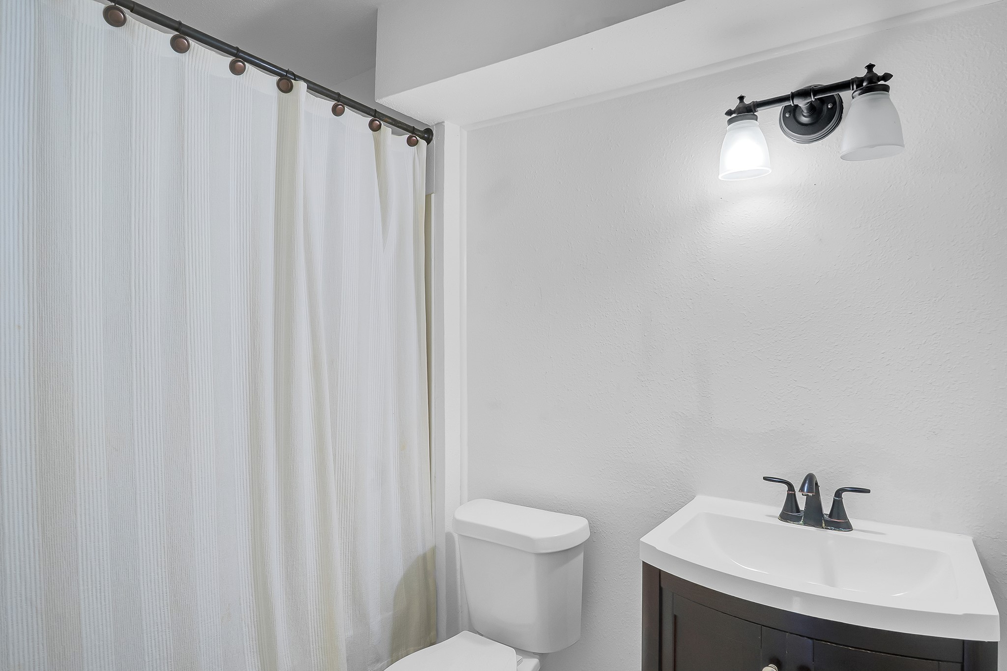 10939 Dunvegan Way Houston, TX 77029 - Photo 20 of 28 a bathroom with a sink a toilet and a mirror