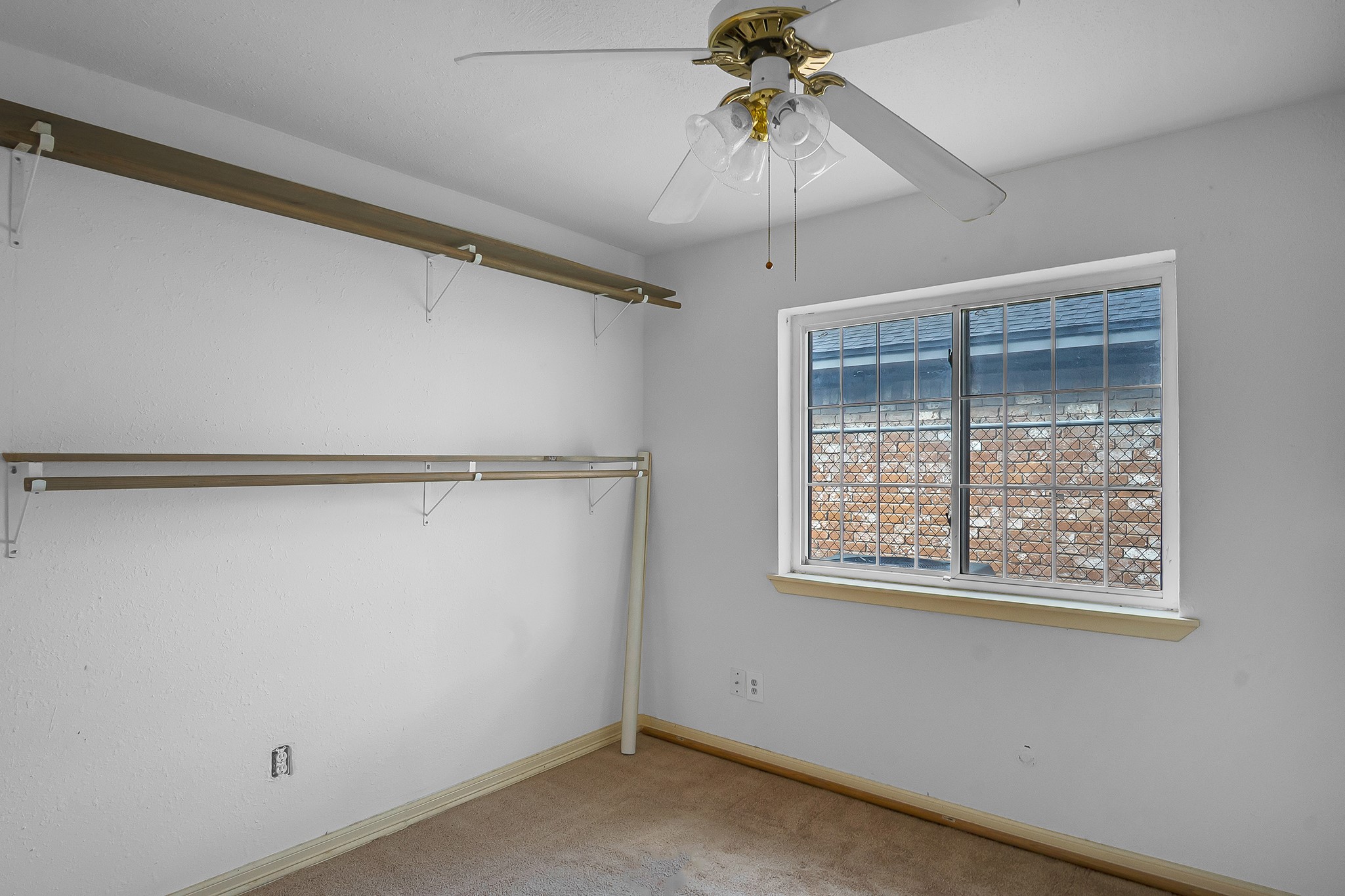 10939 Dunvegan Way Houston, TX 77029 - Photo 21 of 28 an empty room with a window and a fan