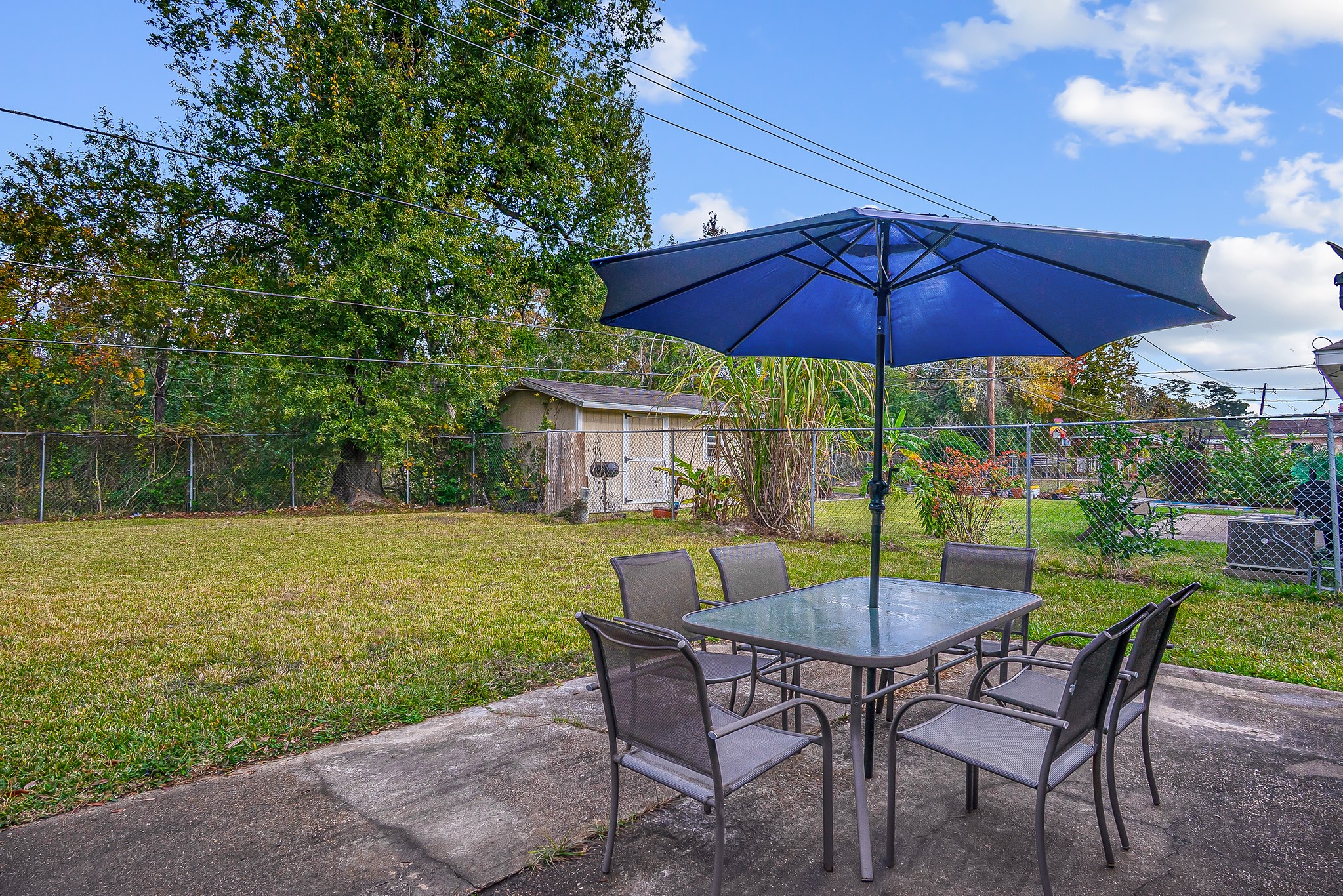 10939 Dunvegan Way Houston, TX 77029 - Photo 28 of 28 a view of a table and chairs under an umbrella