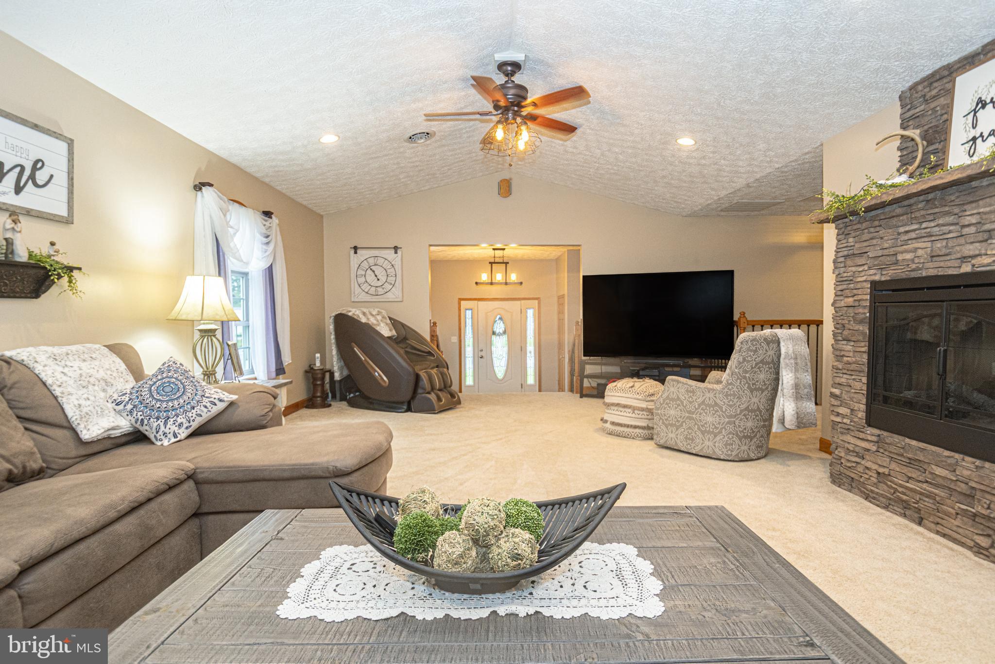 18 Springs Road Grantsville, MD 21536 - Photo 24 of 106 a living room with furniture a fireplace and a flat screen tv