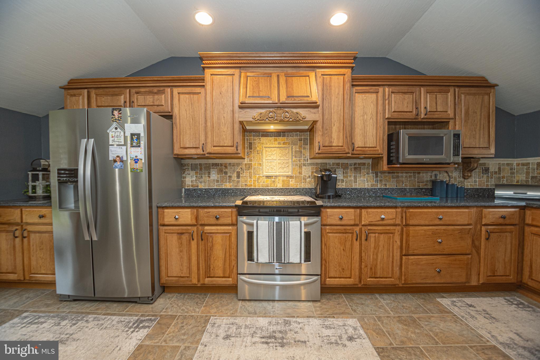 18 Springs Road Grantsville, MD 21536 - Photo 38 of 106 a kitchen with stainless steel appliances granite countertop a refrigerator stove top oven and sink