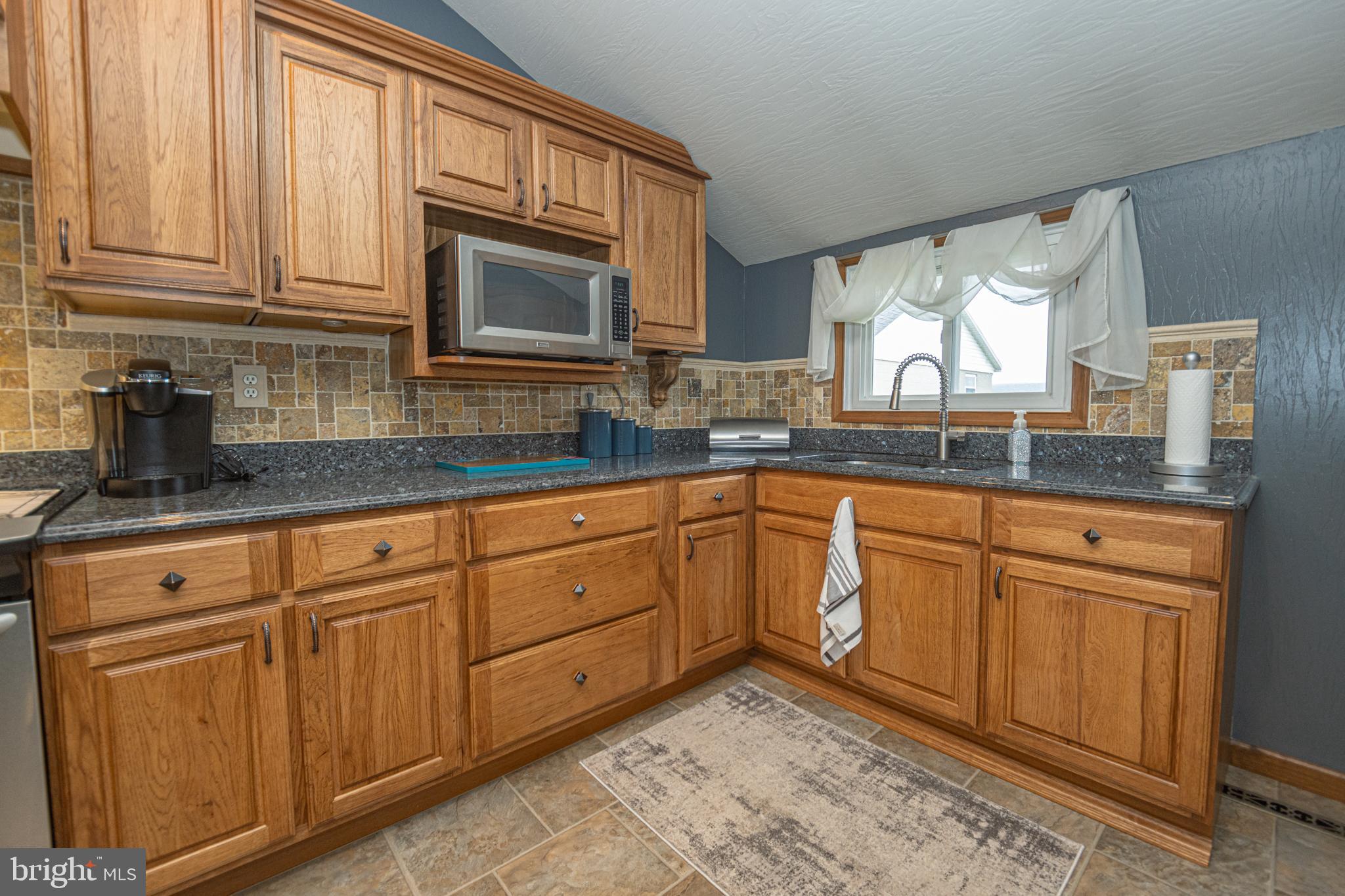 18 Springs Road Grantsville, MD 21536 - Photo 39 of 106 a kitchen with granite countertop cabinets stainless steel appliances a sink and window