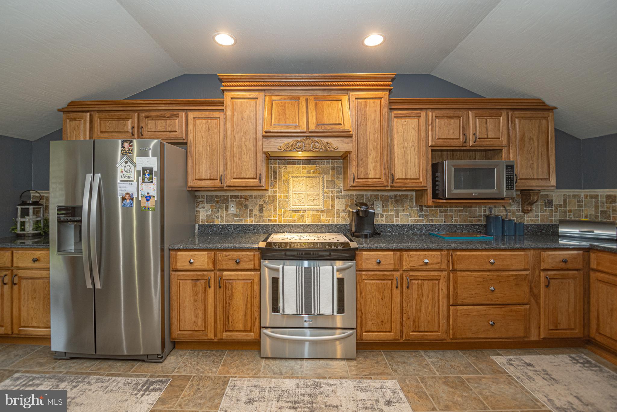 18 Springs Road Grantsville, MD 21536 - Photo 41 of 106 a kitchen with stainless steel appliances granite countertop a refrigerator a stove and a sink