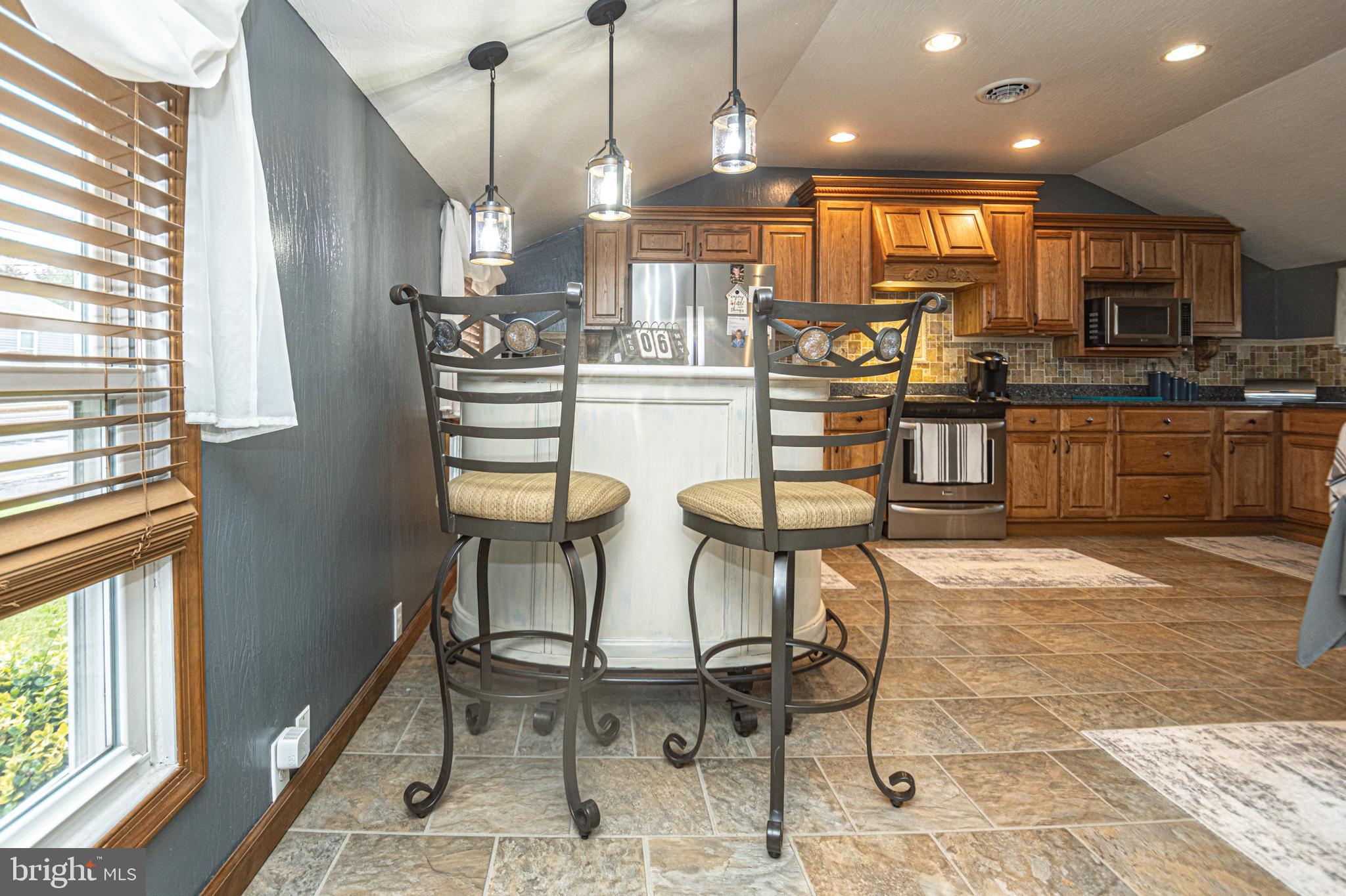18 Springs Road Grantsville, MD 21536 - Photo 45 of 106 a kitchen with stainless steel appliances kitchen island granite countertop a refrigerator and microwave