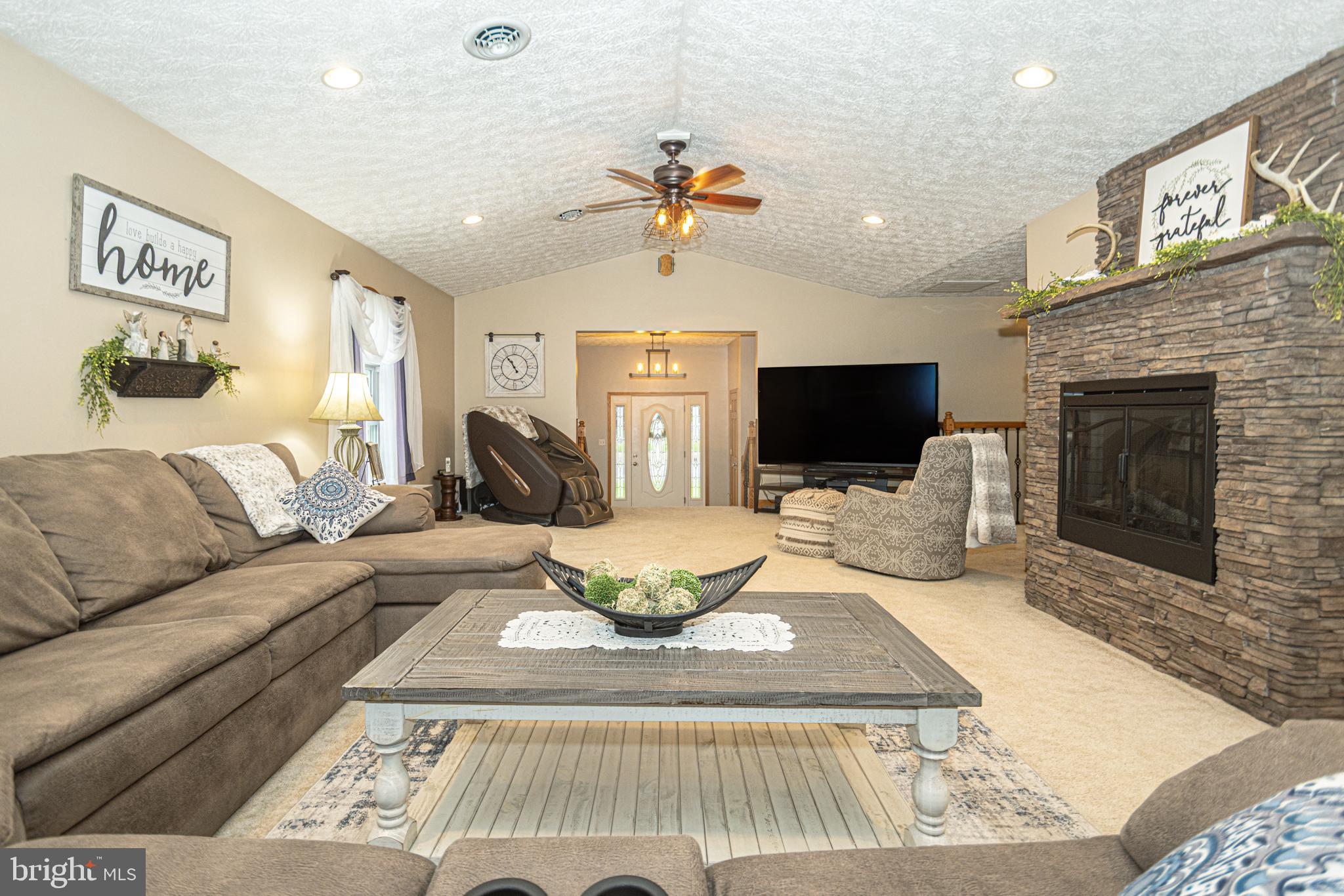 18 Springs Road Grantsville, MD 21536 - Photo 48 of 106 a living room with furniture a flat screen tv and a fireplace
