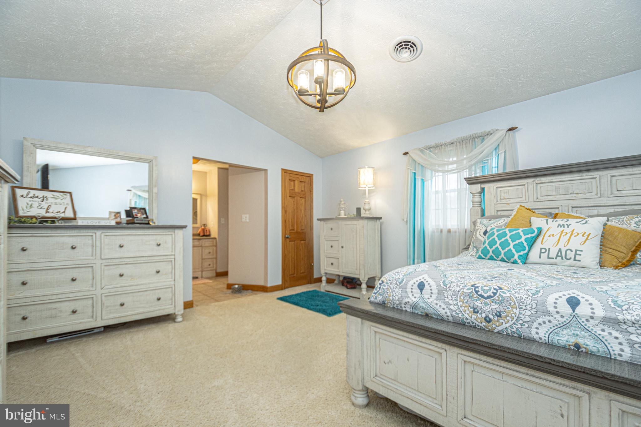 18 Springs Road Grantsville, MD 21536 - Photo 59 of 106 a bedroom with a large bed and a chandelier