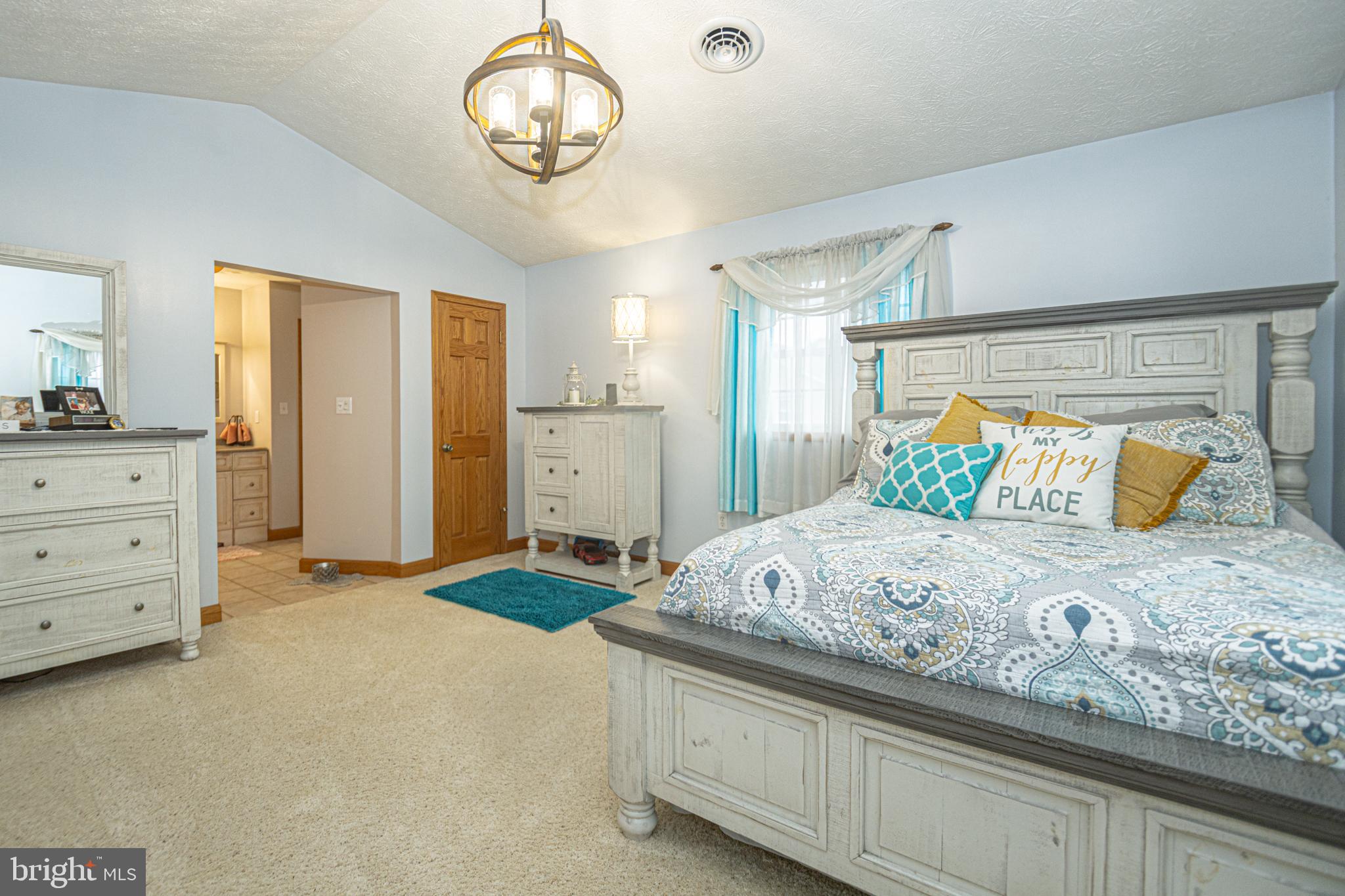 18 Springs Road Grantsville, MD 21536 - Photo 60 of 106 a bedroom with a large bed and a chandelier