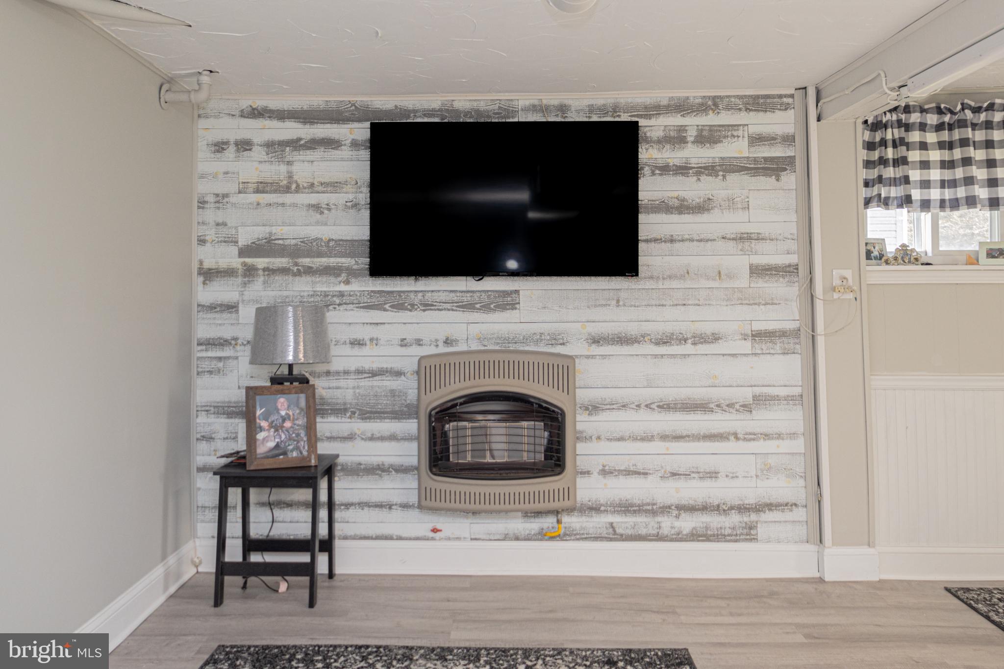 18 Springs Road Grantsville, MD 21536 - Photo 72 of 106 a living room with a fireplace and a flat screen tv
