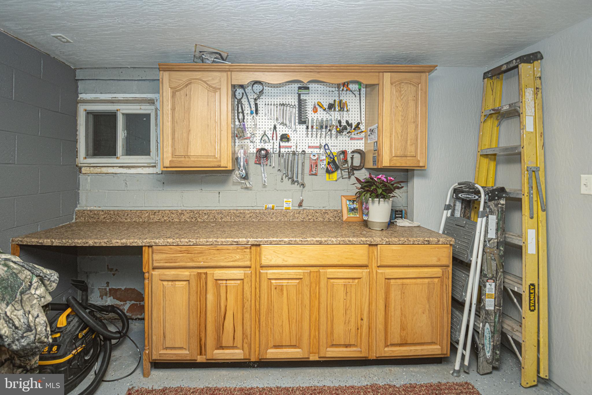 18 Springs Road Grantsville, MD 21536 - Photo 77 of 106 a utility room with stainless steel appliances kitchen island granite countertop a sink and cabinets