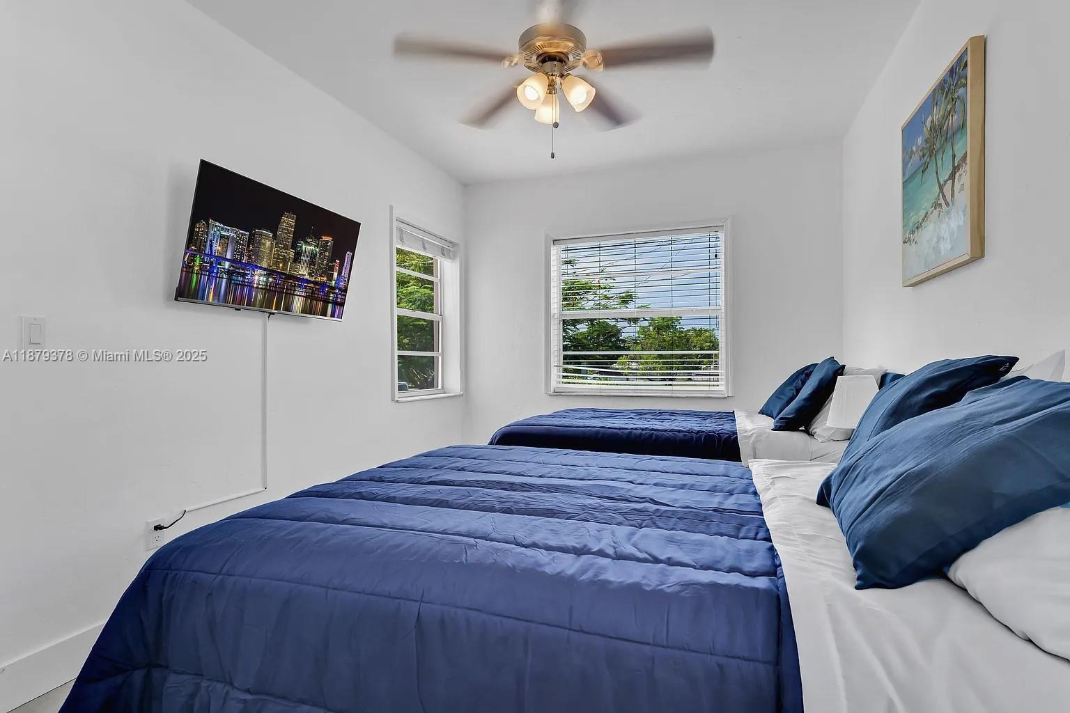 1117 Southwest 13th Street Miami, FL 33129 - Photo 15 of 16 a bedroom with a bed and a window