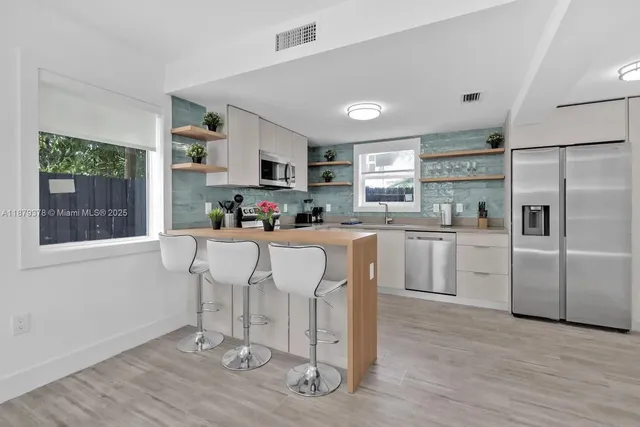 a kitchen with counter top space cabinets and appliances