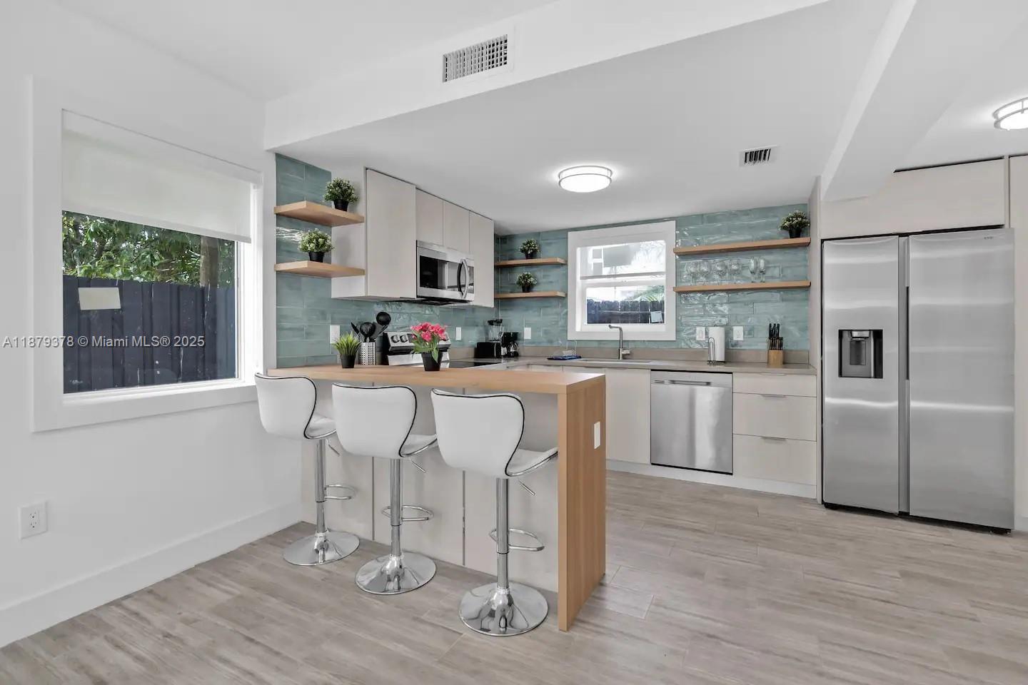 1117 Southwest 13th Street Miami, FL 33129 - Photo 2 of 16 a kitchen with counter top space cabinets and appliances