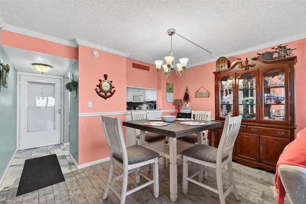 a view of a dining room with furniture and chandelier