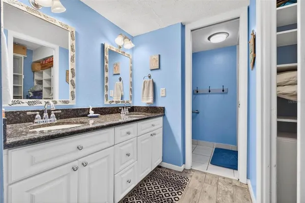 a bathroom with a double vanity sink and a mirror