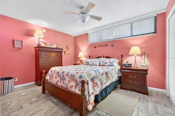 a large bed sitting in a bedroom next to a cabinet