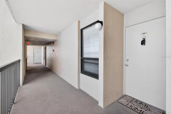 a view of hallway with stairs and a bathroom