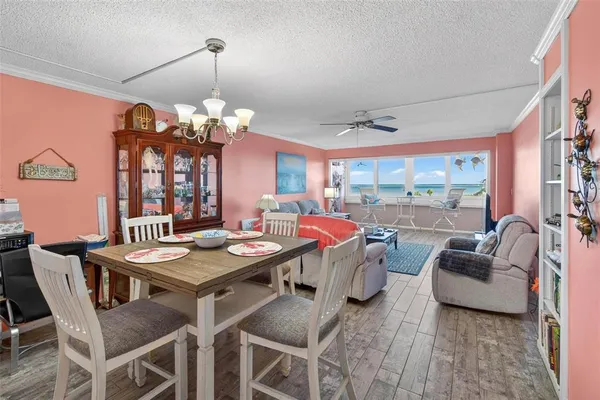 a view of a dining room with furniture wooden floor and chandelier