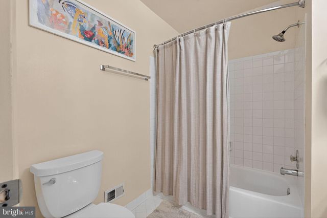 a bathroom with a sink vanity tub and shower
