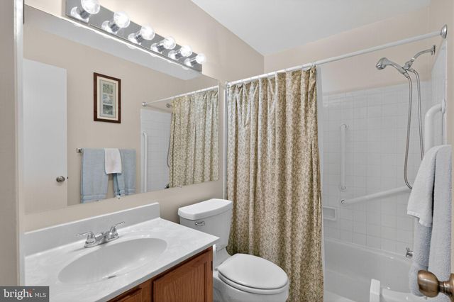 a bathroom with a sink mirror toilet and shower