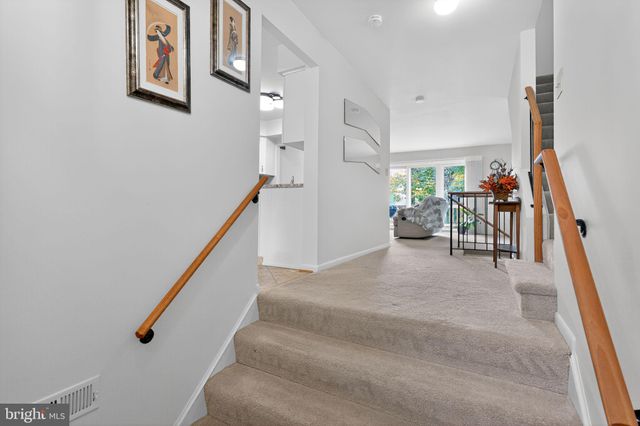 a view of staircase with furniture and stairs