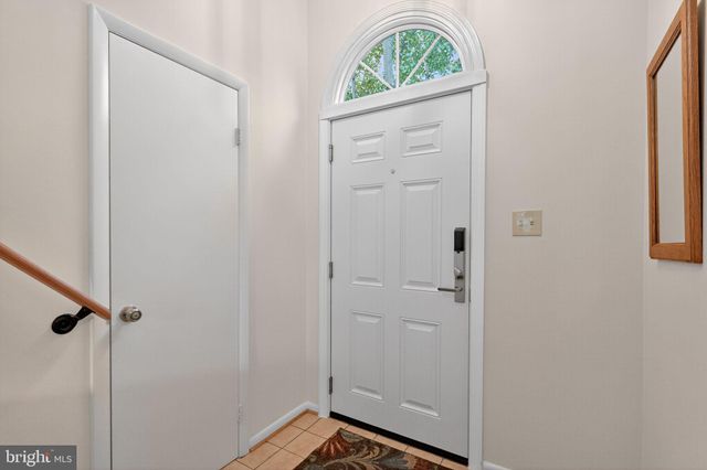 a view of front door with washer and dryer