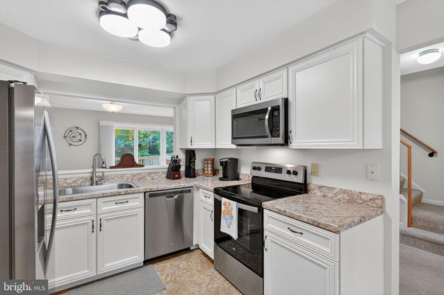 a kitchen with a sink stove and microwave