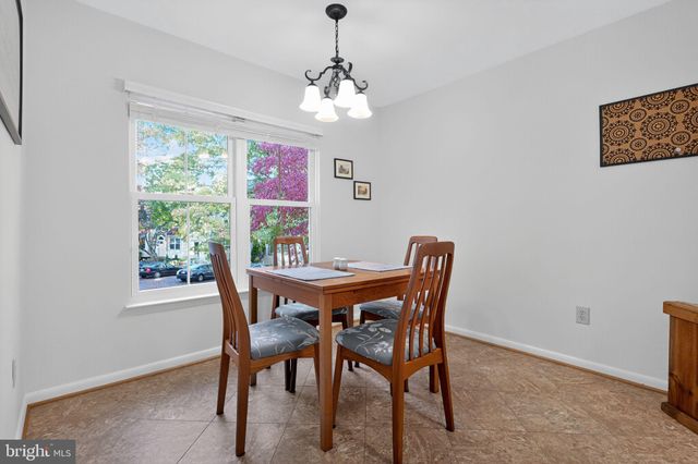 a dining room with furniture a rug and a chandelier