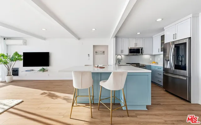 a bathroom with a granite countertop sink a mirror and vanity