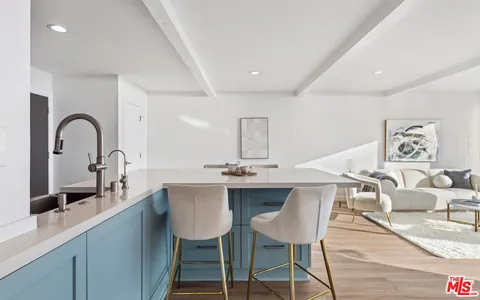 a row of palm trees and swimming pool in the backyard of a house