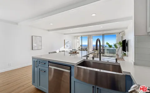 a view of a garden with cars parked