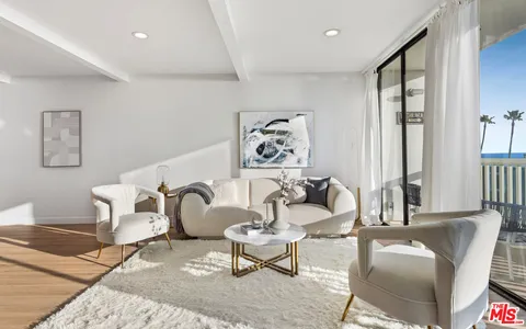 a kitchen with stainless steel appliances kitchen island granite countertop a stove a sink a microwave a refrigerator and a dining table with wooden floor