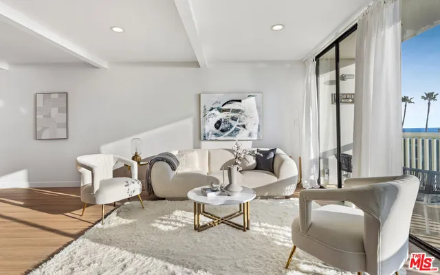 a kitchen with stainless steel appliances kitchen island granite countertop a stove a sink a microwave a refrigerator and a dining table with wooden floor